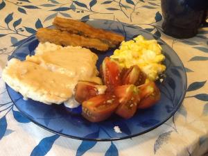 Salt cured side meat from pastured pork, home made biscuit and gravy, my girls's eggs and our tomatoes.